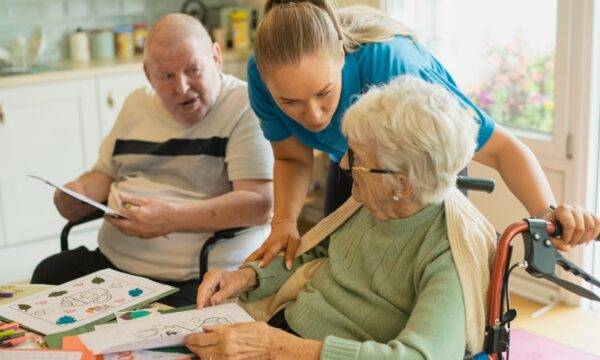 Elderly man receiving home care assistance from a carer and family member in Dublin, Ireland