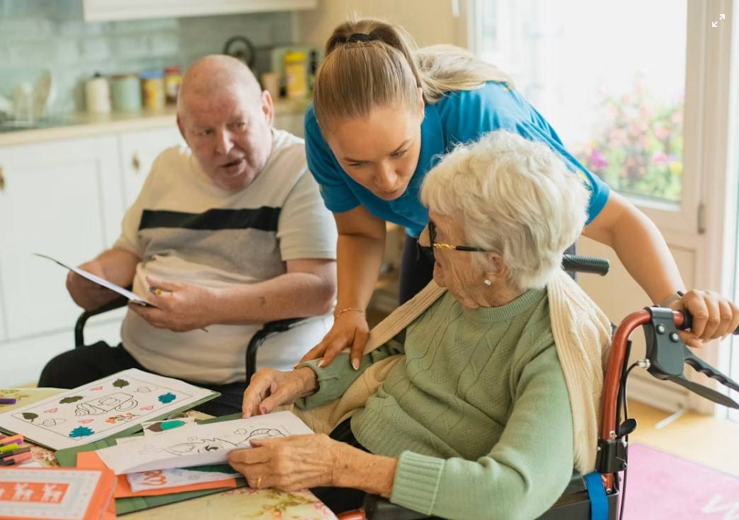 Elderly man receiving home care assistance from a carer and family member in Dublin, Ireland